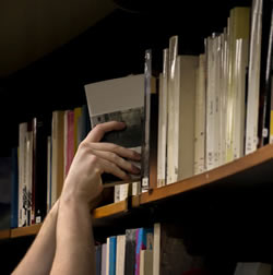 Hand Removing Book from Shelf