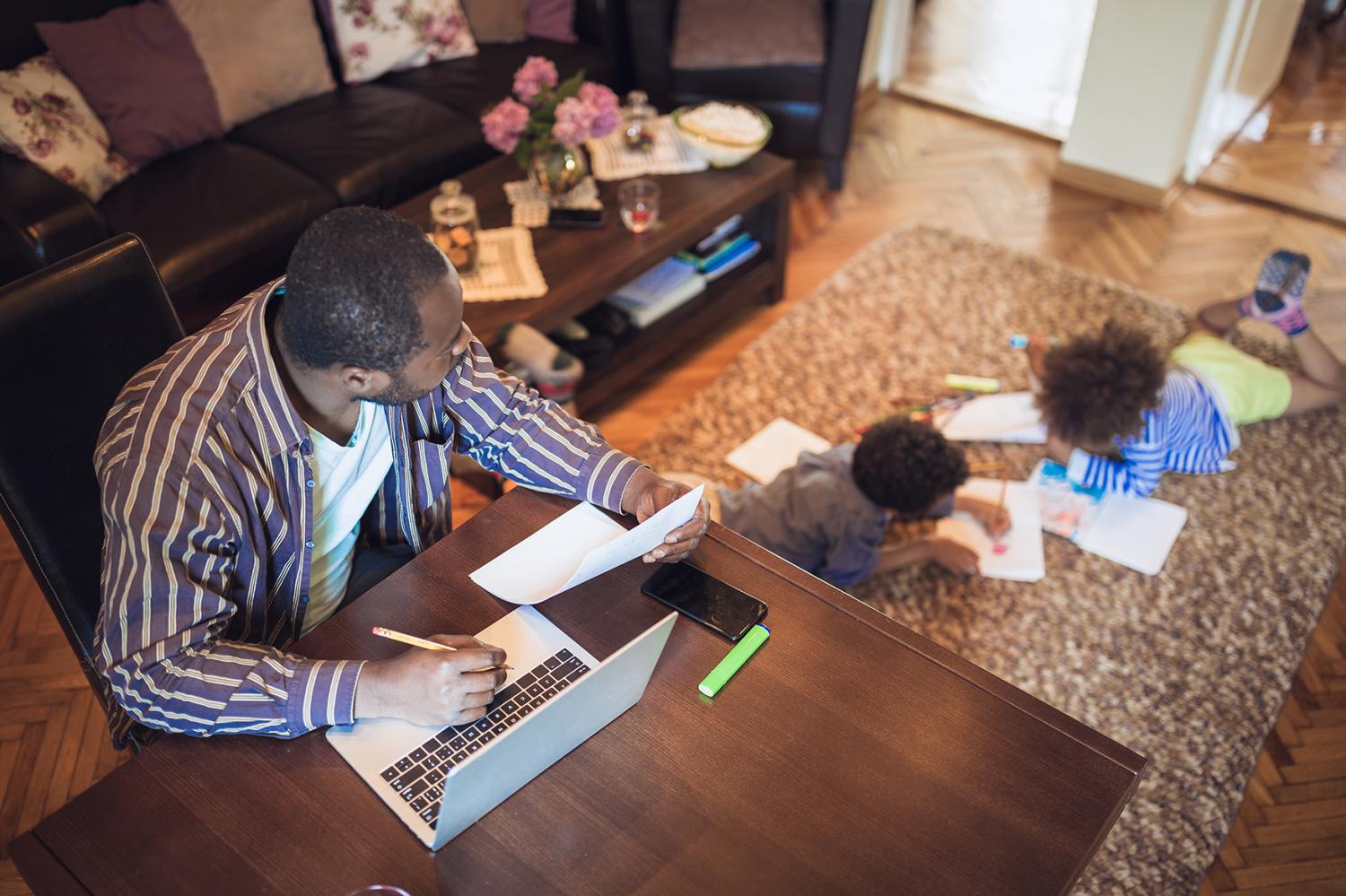 Man on computer with kids