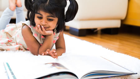 Toddler Girl Enjoying a Book